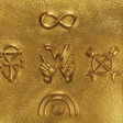 Golden textured vinyl record with embossed symbols and matching gold vinyl sleeve for weezer artifact wzr.004 black gold vinyl signed edition